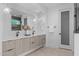 Bright bathroom features double vanity, sleek fixtures, pendant lighting, and tile floors at 1406 Lyon St # 101, Raleigh, NC 27608