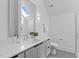 Modern bathroom featuring a gray vanity, sleek fixtures, and a glass-enclosed shower at 1406 Lyon St # 101, Raleigh, NC 27608
