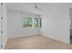 Bright bedroom with recessed lights, ceiling fan, and a large window with wooded views at 1406 Lyon St # 101, Raleigh, NC 27608