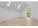 Bright bedroom with light wood floors, large windows, and ample natural light from skylights at 1406 Lyon St # 101, Raleigh, NC 27608