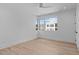 This bedroom features a ceiling fan, hardwood floors, and a large window with city views at 1406 Lyon St # 101, Raleigh, NC 27608