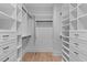 Walk-in closet featuring custom shelving, drawers, and ample storage space at 1406 Lyon St # 101, Raleigh, NC 27608