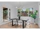 Bright dining room features modern lighting, white walls, wood floors, and sliding glass doors to the exterior at 1406 Lyon St # 101, Raleigh, NC 27608