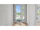 Bright entryway with hardwood floors, light wallpaper, and French doors leading to a view of the neighborhood at 1406 Lyon St # 101, Raleigh, NC 27608