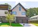 Striking modern home showcasing mixed siding, black-framed windows, and an attached two-car garage with green lawn at 1406 Lyon St # 101, Raleigh, NC 27608