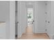 Hallway with light wood floors leads to luxurious bathroom with soaking tub at 1406 Lyon St # 101, Raleigh, NC 27608