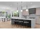 Bright kitchen with a large island, modern lighting, and stainless-steel appliances at 1406 Lyon St # 101, Raleigh, NC 27608