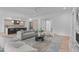 Bright, open floor plan with neutral furniture, hardwood floors, fireplace, and modern kitchen in the background at 1406 Lyon St # 101, Raleigh, NC 27608