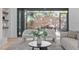 Living room featuring modern furniture, black accents, and an open patio beyond the glass doors at 1406 Lyon St # 101, Raleigh, NC 27608