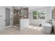 Bright bathroom with glass enclosed shower and soaking tub at 1406 Lyon St # 101, Raleigh, NC 27608