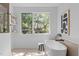 Bright main bathroom features a modern soaking tub and a large window at 1406 Lyon St # 101, Raleigh, NC 27608