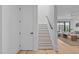 Bright open staircase features wood treads and white risers, leading to the living room at 1406 Lyon St # 101, Raleigh, NC 27608