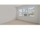 Empty bedroom filled with natural light featuring three sunny windows at 160 Scenic Rock Dr, Youngsville, NC 27596
