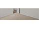 Empty bedroom with neutral carpet and a view into the hallway at 160 Scenic Rock Dr, Youngsville, NC 27596