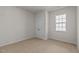 Empty bedroom features a double door closet and a bright window at 160 Scenic Rock Dr, Youngsville, NC 27596