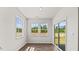 Cozy sunroom features large windows and sliding glass door at 160 Scenic Rock Dr, Youngsville, NC 27596