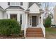 Inviting entryway with brick steps, white railing, and decorative door with house number at 1909 Somerset Hills Ct, Raleigh, NC 27604