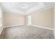 A carpeted bedroom with trey ceilings, neutral walls, and a bright, airy atmosphere at 1985 Meadowview Dr, Graham, NC 27253