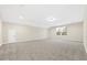 Large bonus room with neutral carpeting, recessed lighting, and a window offering natural light at 1985 Meadowview Dr, Graham, NC 27253