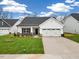 Charming single Gathering home with a manicured lawn, attached garage, and beautiful curb appeal at 1985 Meadowview Dr, Graham, NC 27253