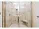 Beautifully tiled shower with glass doors and a built-in seat at 1985 Meadowview Dr, Graham, NC 27253