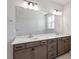 Bathroom with double vanity sinks, modern fixtures, and a large mirror at 203 Frosted Iris Lane St # 181, Garner, NC 27529