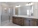 Bathroom featuring double vanity sinks, neutral tiling and walk-in shower at 203 Frosted Iris Lane St # 181, Garner, NC 27529