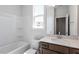 Full bathroom featuring modern vanity, white tub/shower combo and natural light at 203 Frosted Iris Lane St # 181, Garner, NC 27529