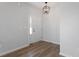 Inviting entryway with hardwood floors, fresh paint, and modern light fixture at 203 Frosted Iris Lane St # 181, Garner, NC 27529