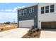 New construction exterior of a townhome featuring 2-car garage and modern siding at 203 Frosted Iris Lane St # 181, Garner, NC 27529