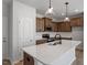 Modern kitchen featuring quartz countertops, stainless appliances, and hardwood floors at 203 Frosted Iris Lane St # 181, Garner, NC 27529