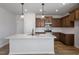 Modern kitchen featuring quartz countertops, stainless appliances, and hardwood floors at 203 Frosted Iris Lane St # 181, Garner, NC 27529