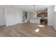 Open-concept living room showcasing the hardwood floors, modern light fixture, and kitchen at 203 Frosted Iris Lane St # 181, Garner, NC 27529