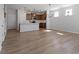 Open-concept living room with hardwood floors, modern light fixture, and lots of natural light at 203 Frosted Iris Lane St # 181, Garner, NC 27529