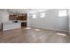 Spacious open-concept living room with hardwood floors and modern light fixtures at 203 Frosted Iris Lane St # 181, Garner, NC 27529
