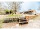 View of backyard featuring brick retaining wall, steps and the back of the house at 2104 Live Oak Dr, Sanford, NC 27330