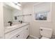 Bathroom features a granite vanity with double sinks, toilet and natural light at 2104 Live Oak Dr, Sanford, NC 27330