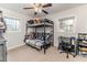 A bedroom with a bunk bed, ceiling fan, and two windows for natural light at 2104 Live Oak Dr, Sanford, NC 27330