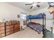 A bedroom with a bunk bed, a window, ceiling fan, and a dresser at 2104 Live Oak Dr, Sanford, NC 27330