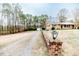 Wide shot of the home's exterior showing a long drive and garage at 2104 Live Oak Dr, Sanford, NC 27330