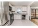 Well-lit kitchen with updated appliances, white cabinets, and granite countertops at 2104 Live Oak Dr, Sanford, NC 27330