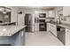 Bright modern kitchen with stainless appliances, white cabinets, and granite countertops at 2104 Live Oak Dr, Sanford, NC 27330