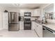 Modern kitchen featuring stainless steel appliances, white cabinets, and granite counters at 2104 Live Oak Dr, Sanford, NC 27330