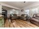 Living room with a view of the fireplace, dining room, and wood floors at 2104 Live Oak Dr, Sanford, NC 27330