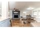 Open floorplan living room featuring a fireplace, dining table, and view of kitchen at 2104 Live Oak Dr, Sanford, NC 27330