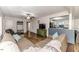 Comfortable living room showcasing wood flooring and a partial view of the kitchen at 2104 Live Oak Dr, Sanford, NC 27330