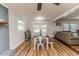 Bright living room with large windows, dining table, and hardwood flooring at 2104 Live Oak Dr, Sanford, NC 27330