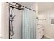 A full shower with a shower curtain with a granite vanity and toilet at 2104 Live Oak Dr, Sanford, NC 27330