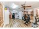 Sunroom with gym equipment, lots of light, ceiling fan, laundry and fridge at 2104 Live Oak Dr, Sanford, NC 27330