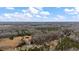 Wide aerial view of a sprawling wooded property dotted with homes and structures at 2232 Miller Rd, Hillsborough, NC 27278